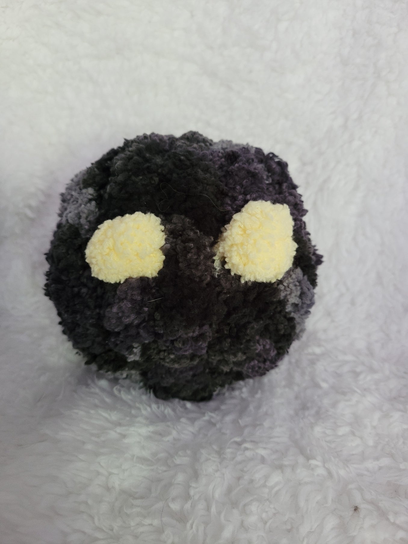 Handmade black and gray Desk Buddy plush with soft yellow yarn eyes