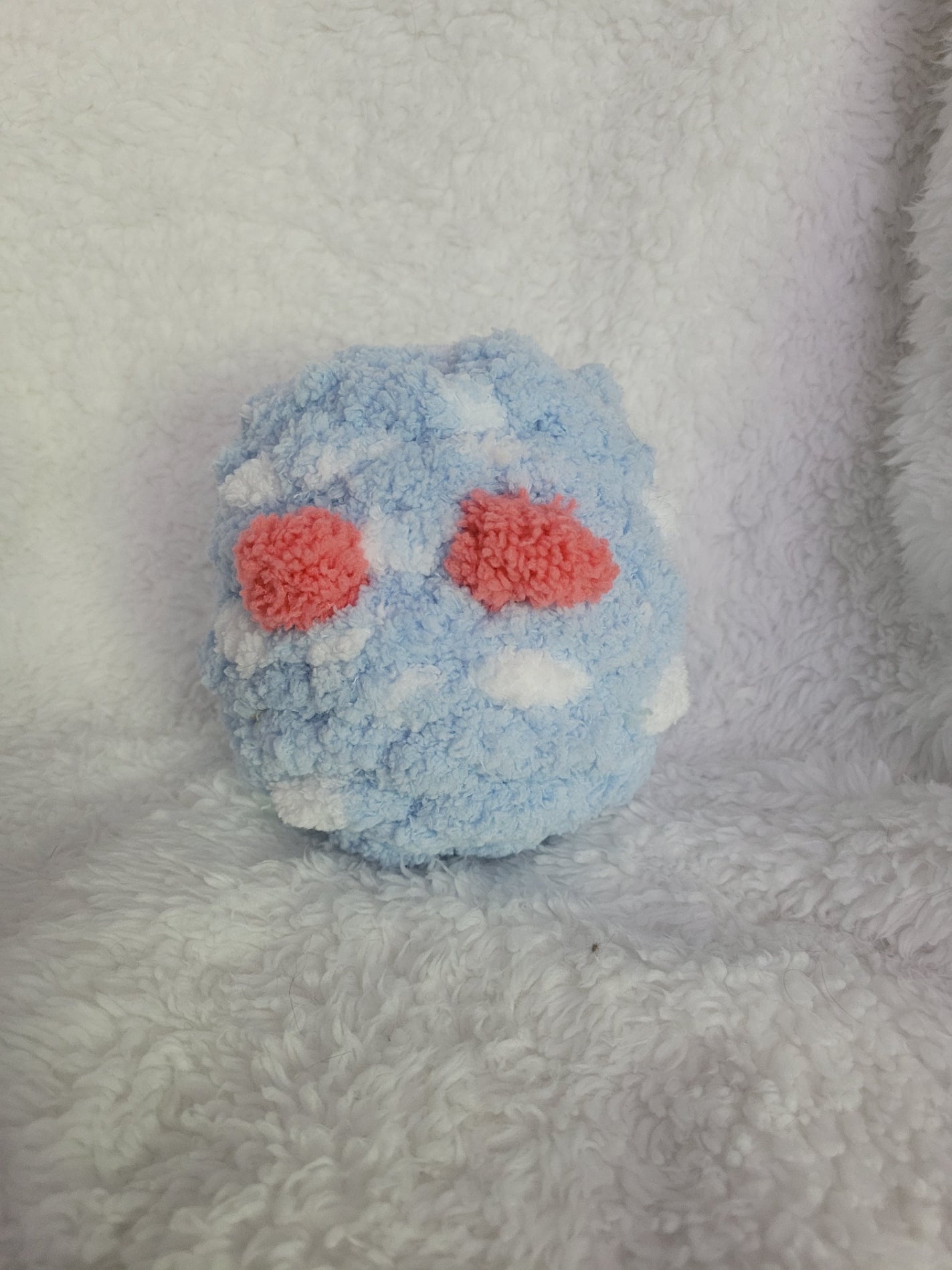 Handmade blue and white Desk Buddy plush with soft terra cotta yarn eyes
