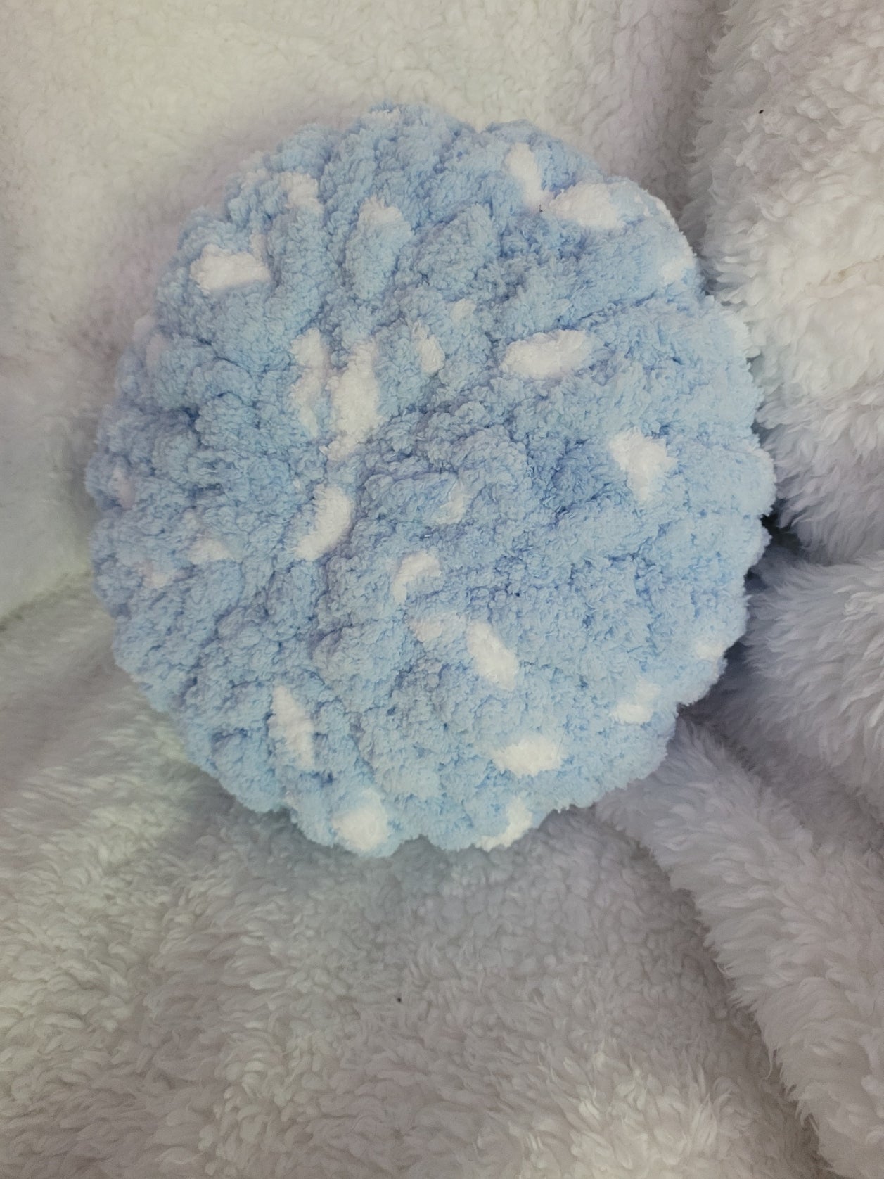 Handmade white round chunky chenille pillow with blue accents