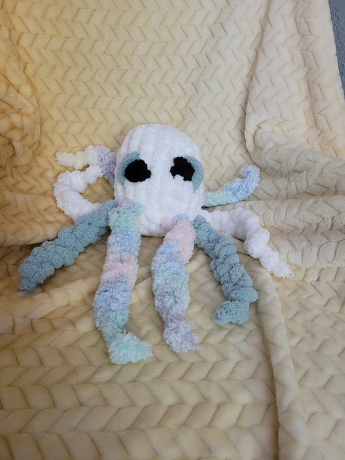 Casper the Ghost Octopus sitting upright with eight legs.