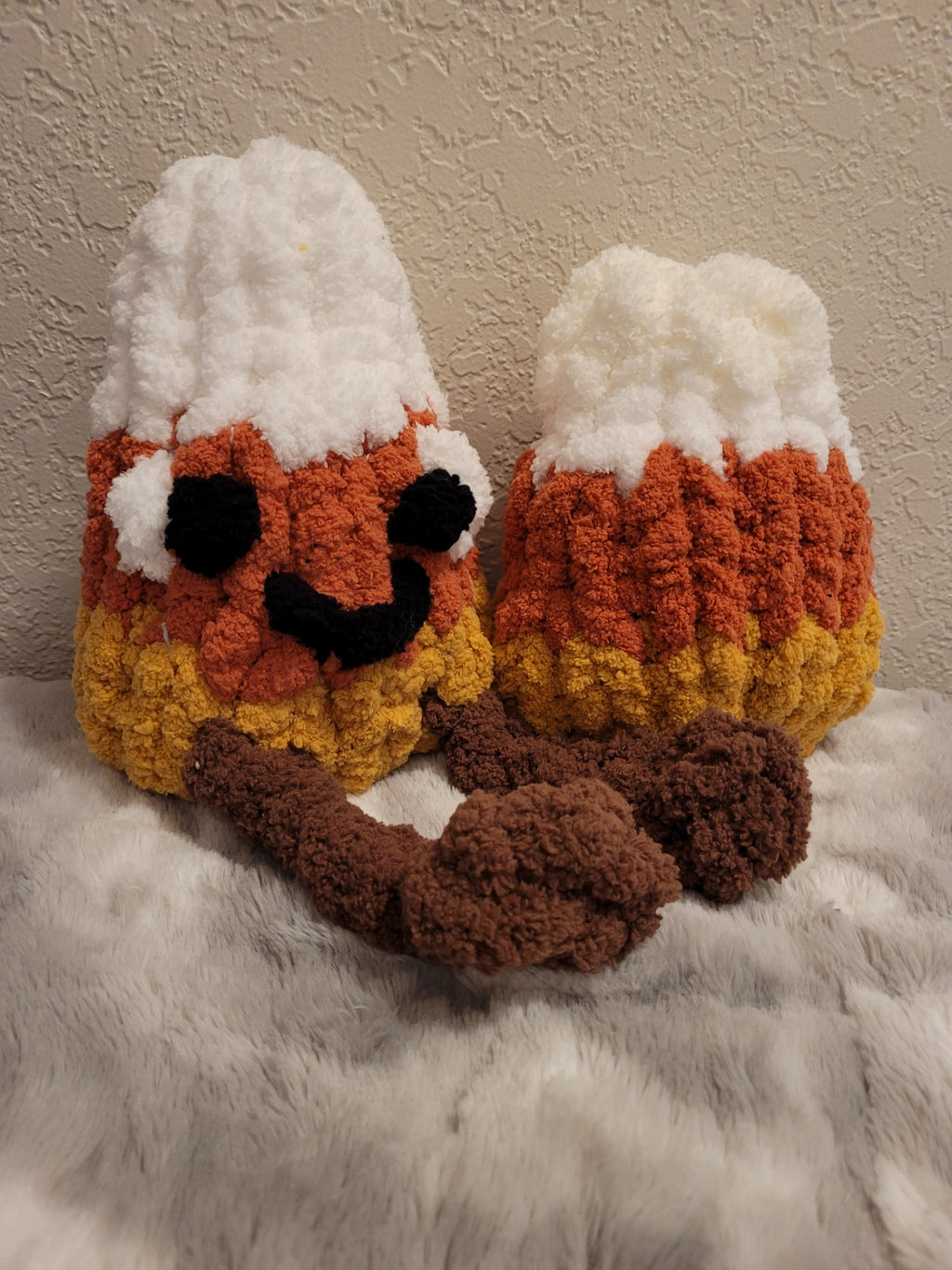Handmade chenille candy corn plushies close‑up
