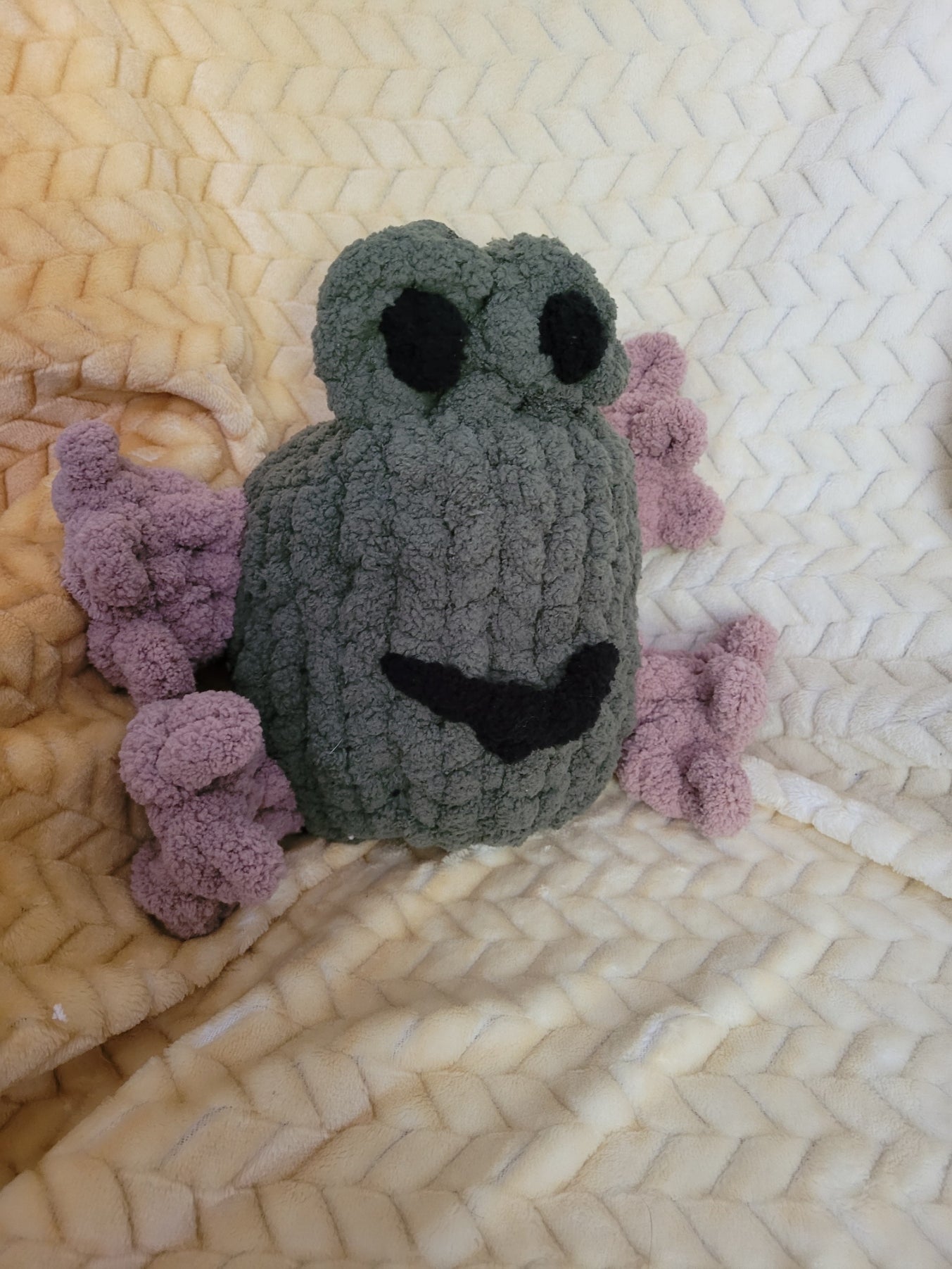Froodle the frog plush sitting upright with raised eyes