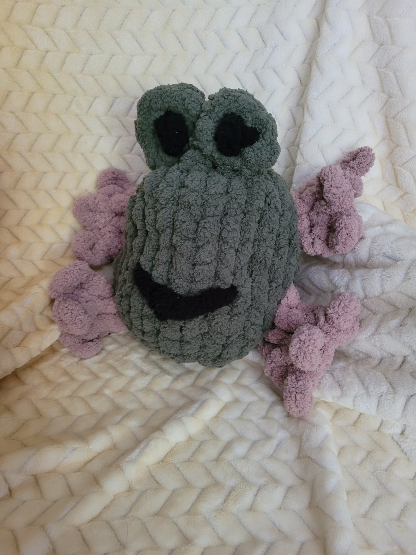 Froodle the frog plush sitting upright with raised eyes