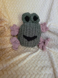 Froodle the frog plush sitting upright with raised eyes