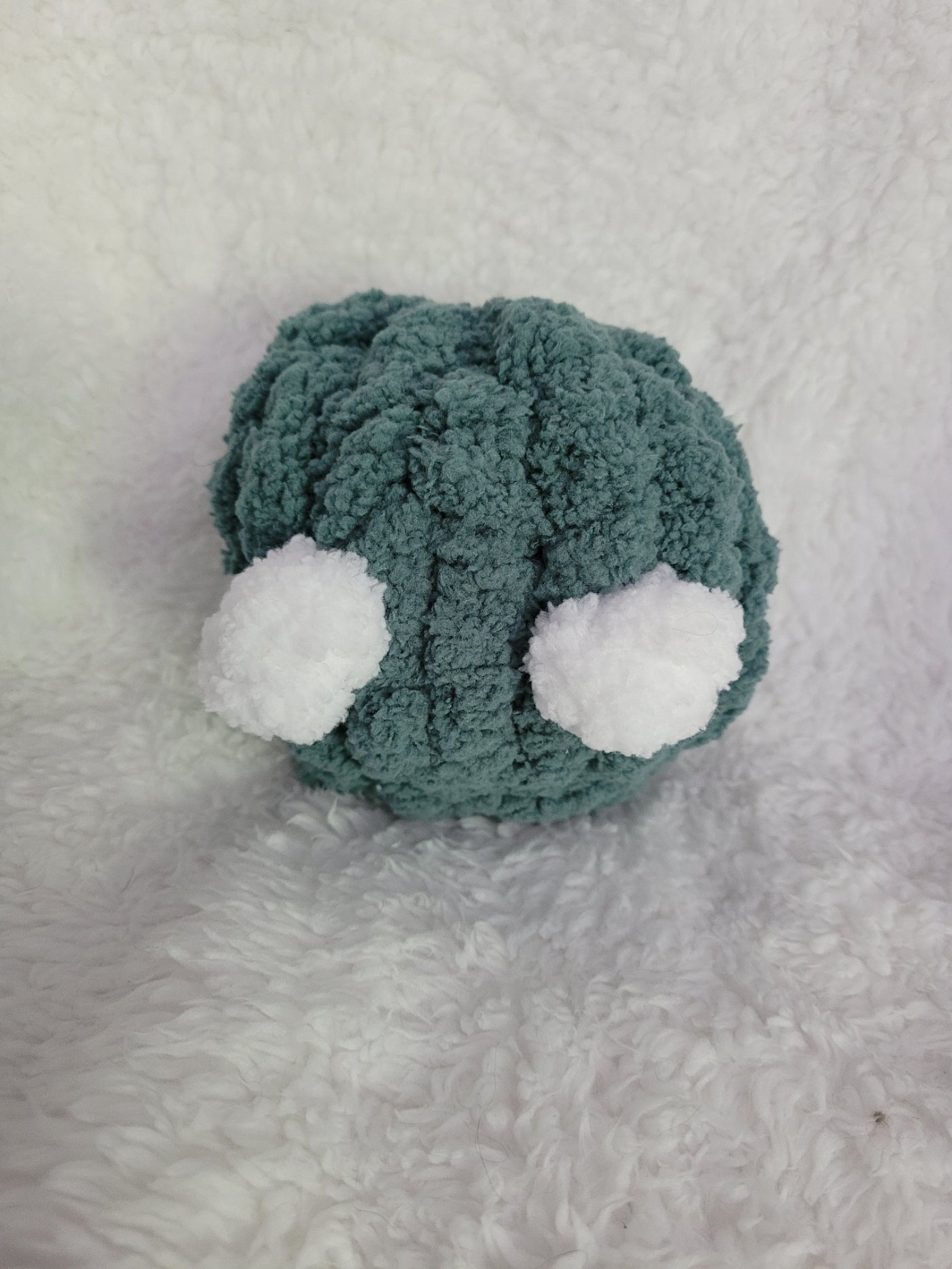 Handmade green Desk Buddy plush with soft white yarn eyes