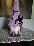 Hand knit purple Halloween gnome with tall chenille hat, bat and spider decorations, white beard and wooden bead nose — Magnus by CozyByBeverly