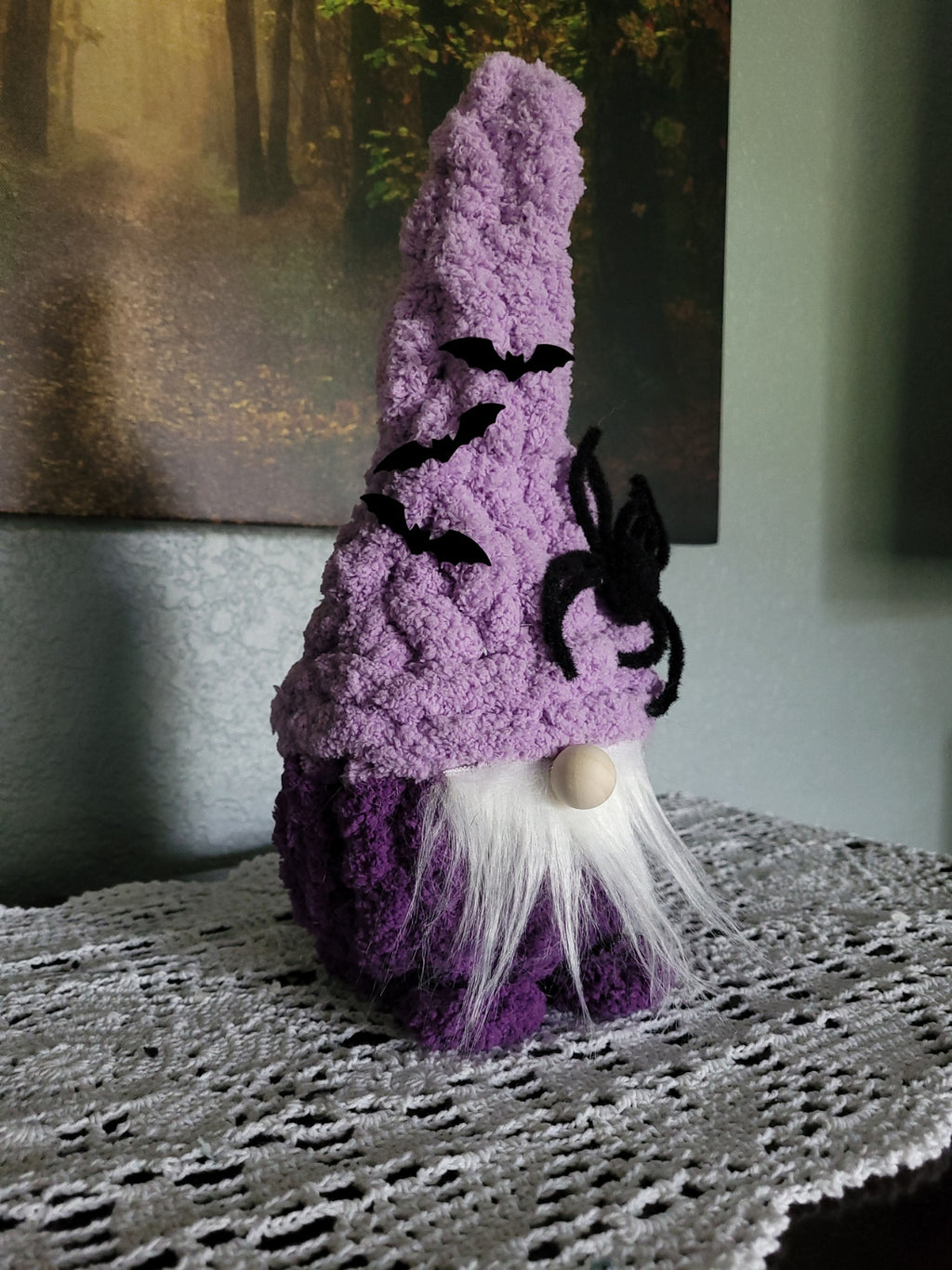 Side angle of Magnus, a hand knit Halloween gnome in purple chunky chenille yarn with bat hat details by CozyByBeverly