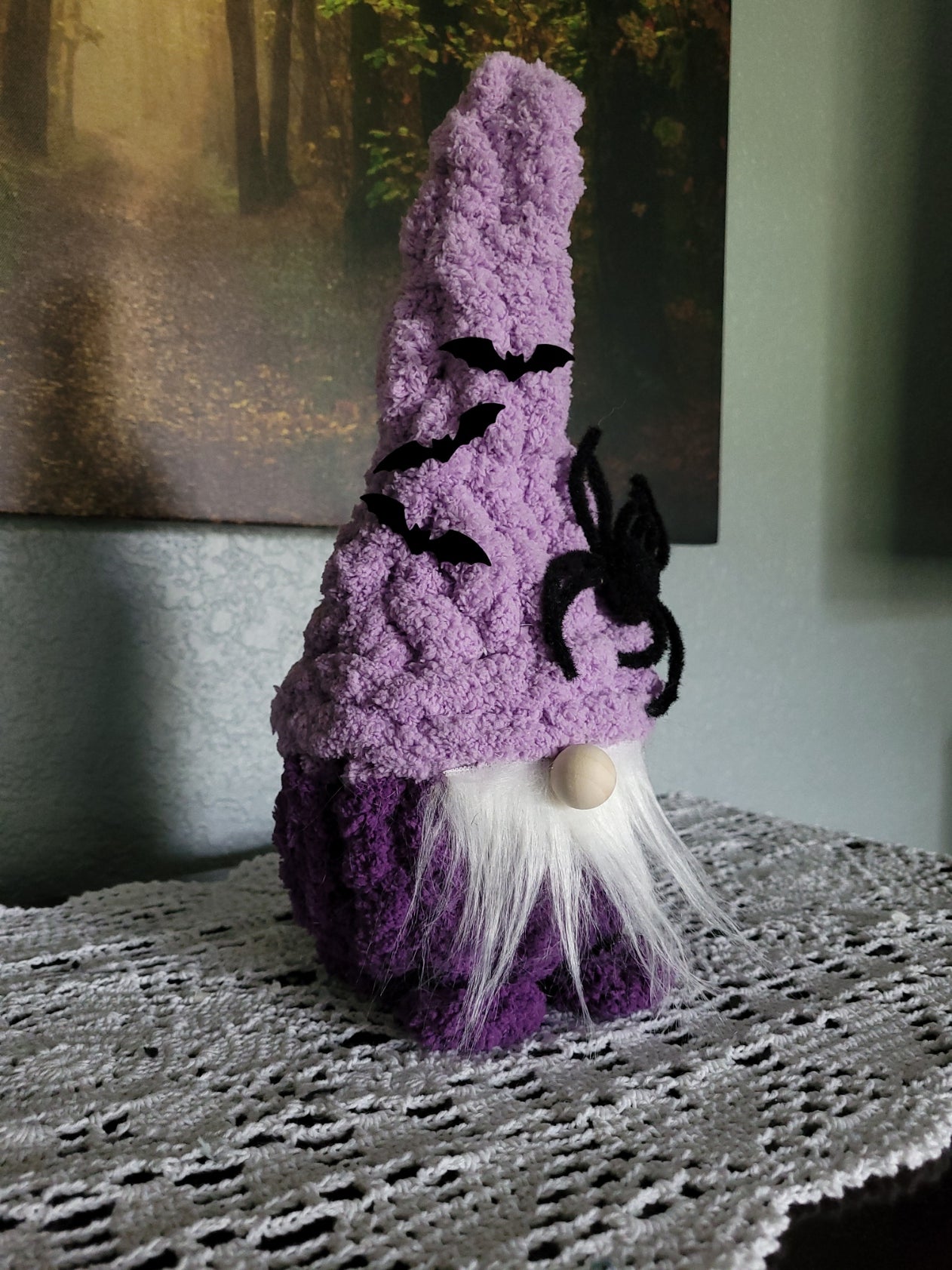 Side angle of Magnus, a hand knit Halloween gnome in purple chunky chenille yarn with bat hat details by CozyByBeverly