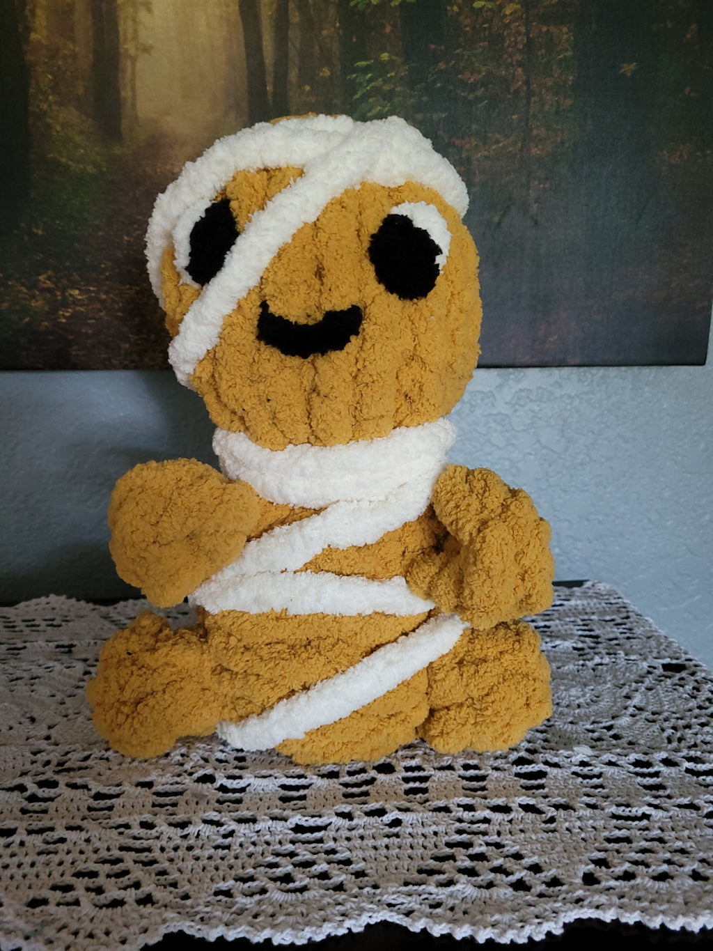 Hand knit golden-brown mummy plush with white chenille yarn wrapping and a friendly face — Tatterby by CozyByBeverly