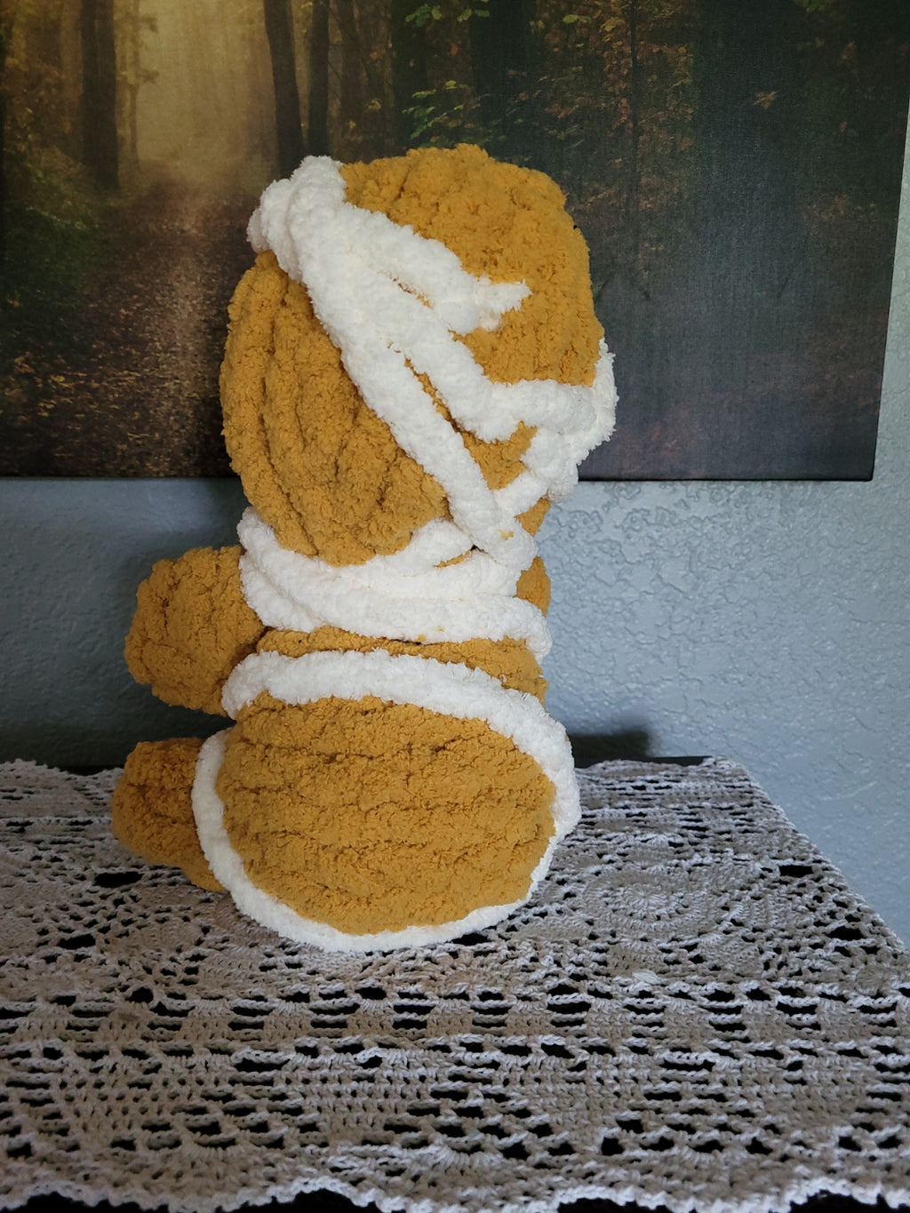 Back view of Tatterby the mummy plush showing hand knit golden-brown chenille yarn and white wrap detail by CozyByBeverly