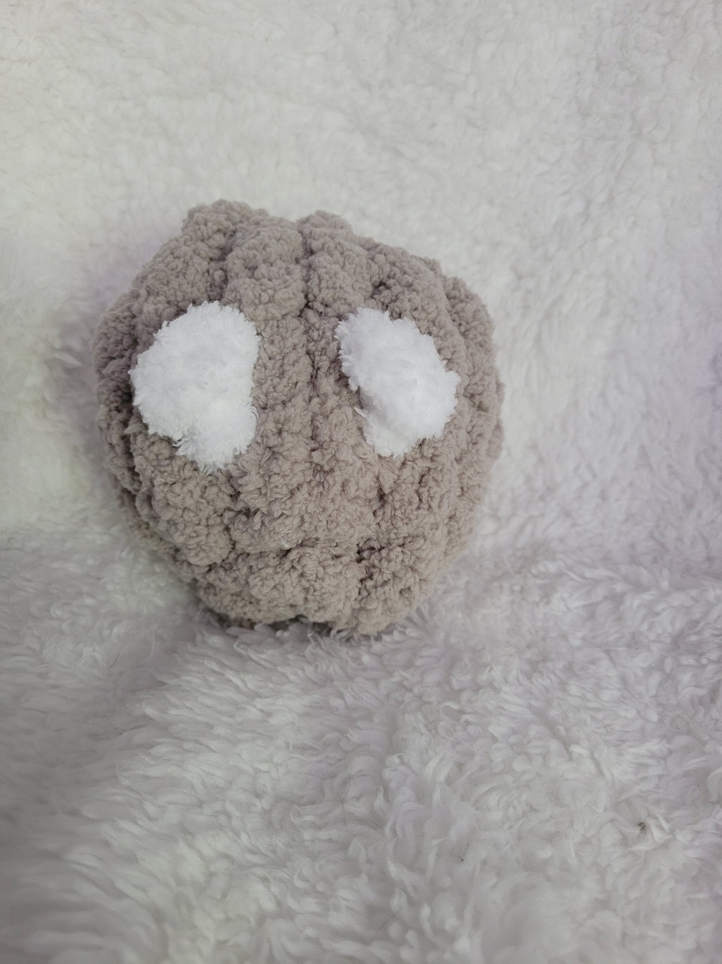 Handmade taupe Desk Buddy plush with soft white yarn eyes