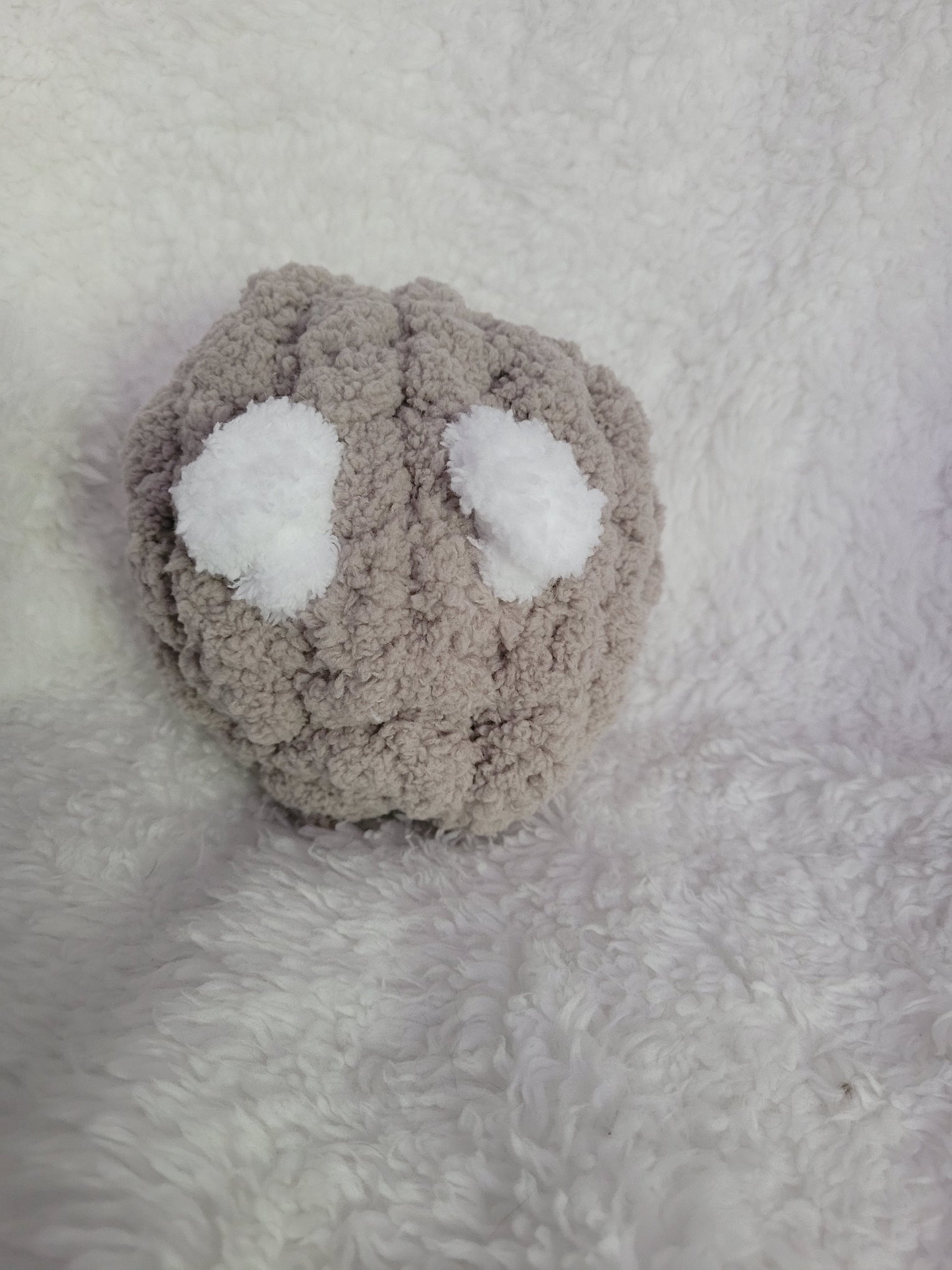 Handmade taupe Desk Buddy plush with soft white yarn eyes