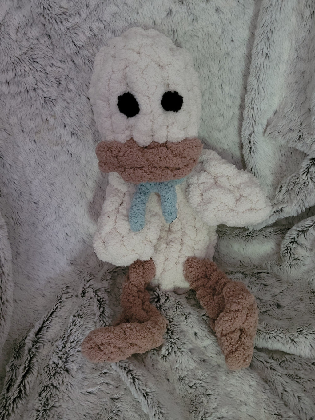 Handmade beige duck plushie named Webby with dangling feet and teal scar