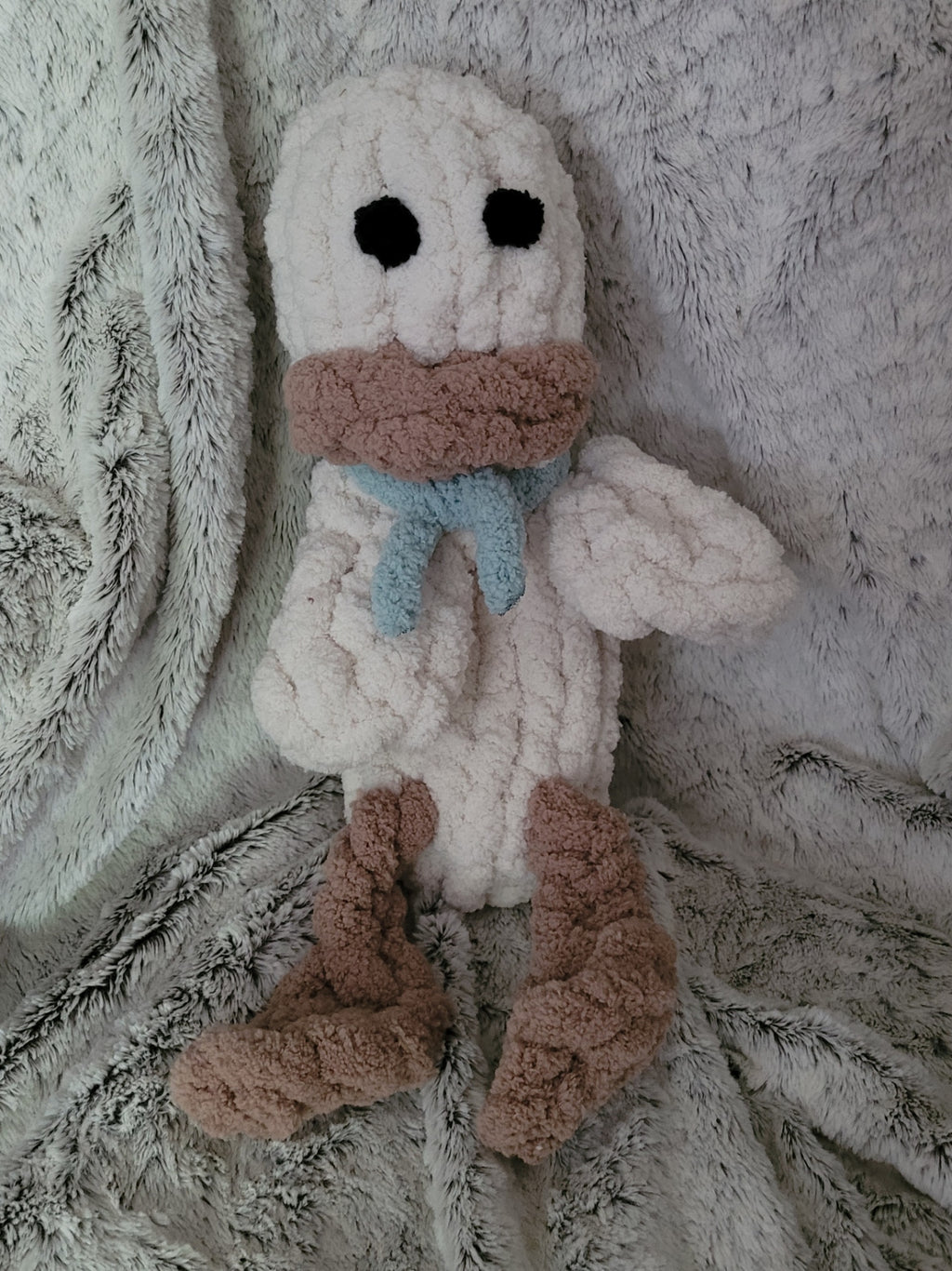 Handmade beige duck plushie named Webby with dangling feet and teal scar