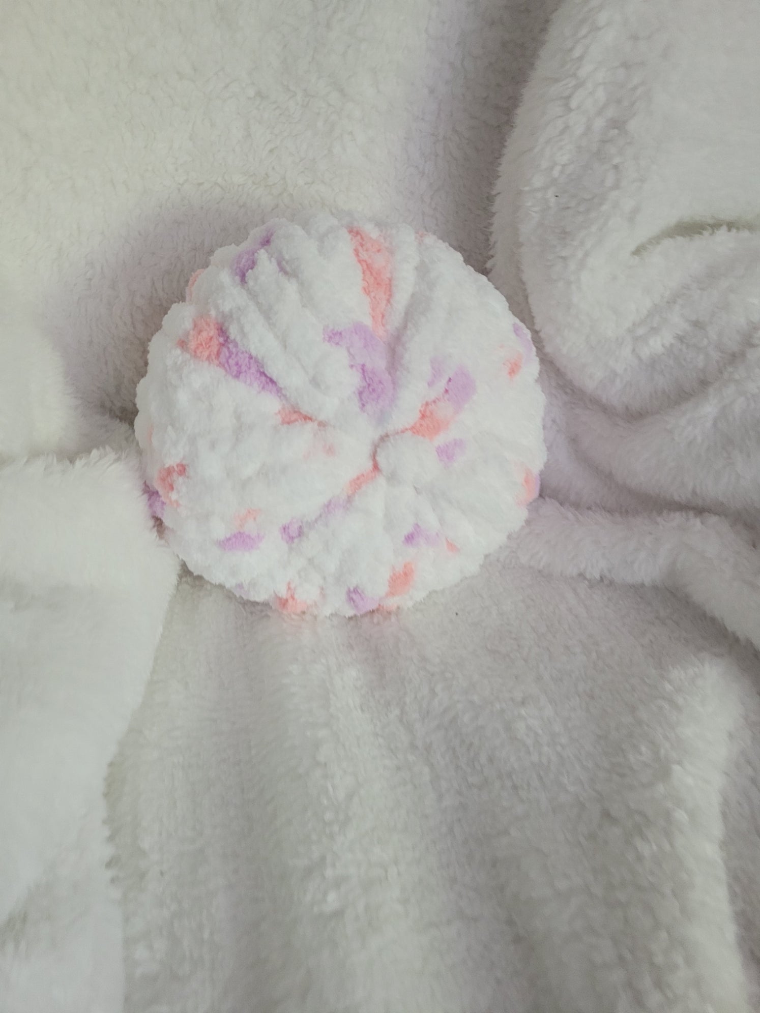 Handmade white round chunky chenille pillow with pink and lilac accents