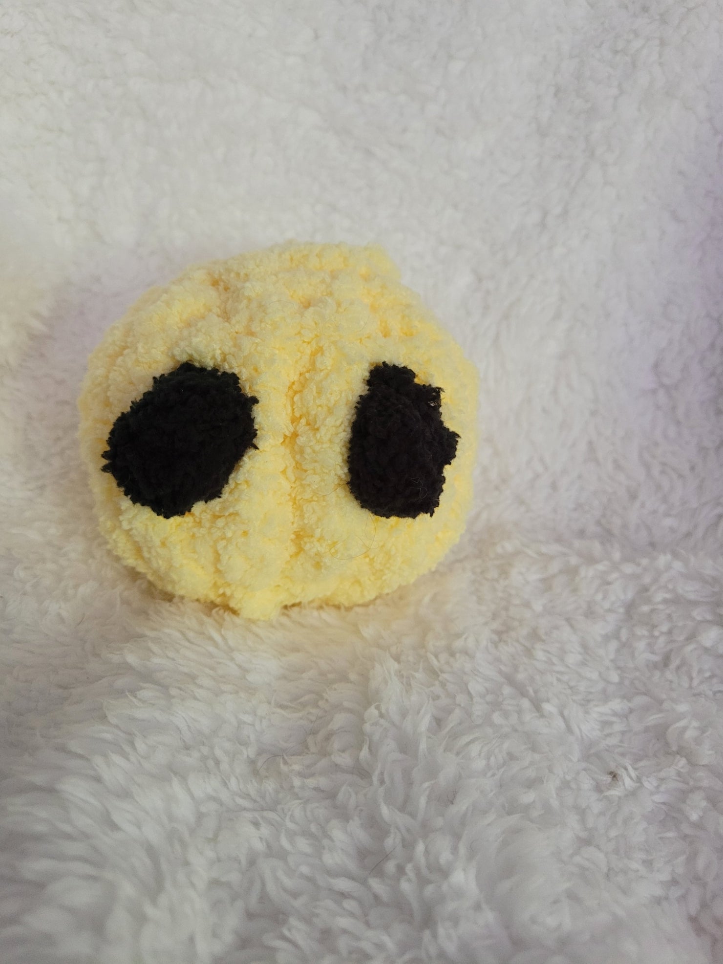 Handmade yellow Desk Buddy plush with soft black yarn eyes